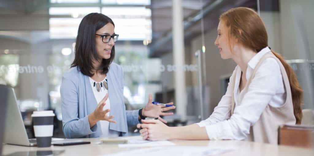 Coaching and advise, two business woman working together.