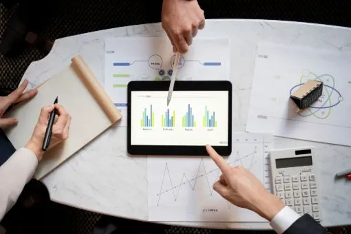 person analysing data driven recruitment metrics on a tablet screen, pen pointing at the screen
